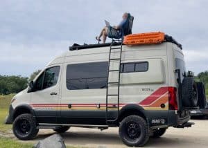 Pause for work on top of a VanSolo 2023 Storyteller Overland Beast Mode 4x4 Mercedes Sprinter.
