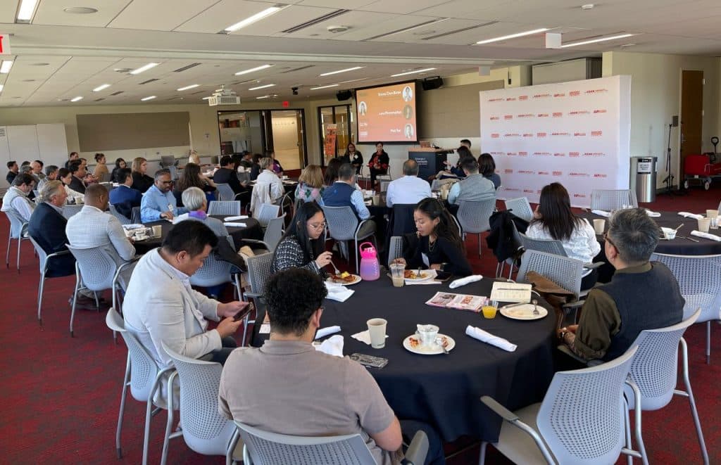 Attendees of the AAPI Roundtable Breakfast listen to the panel discussion while enjoying their meal.